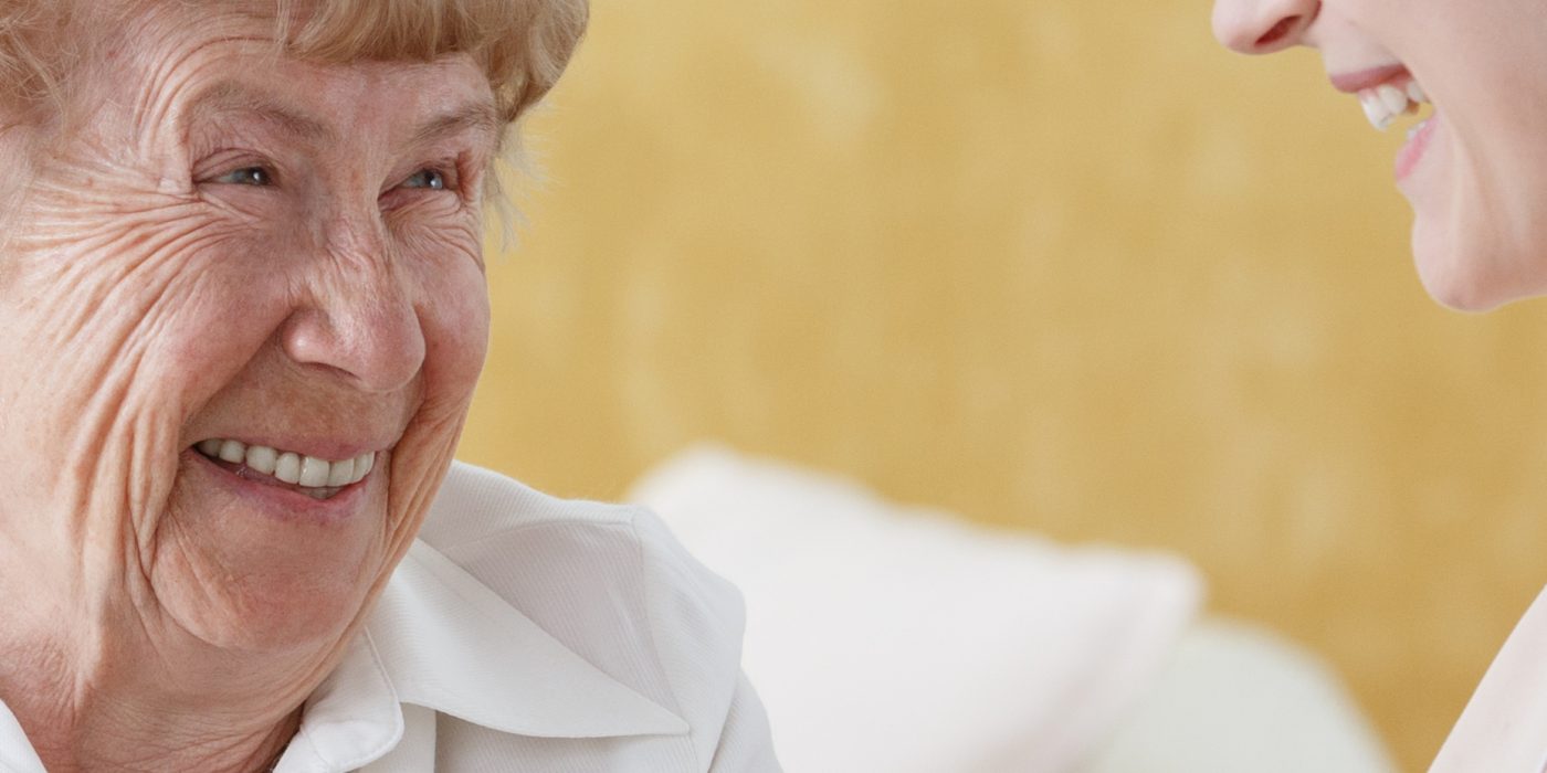 Older woman talking with caretaker